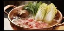 Swishing a thin slice of wagyu in the broth