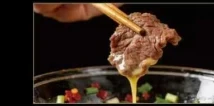 Dipping cooked wagyu into sauce